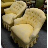 A Victorian button back armchair with gold brocade upholstery and matching ladies chair