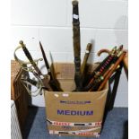 A box containing a group of reproduction swords and axes, a morning star, various canes etc