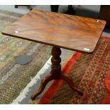 A mahogany tilt top table