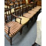 A set of seven late George III mahogany dining chairs including one carver (repairs)