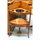 A George III mahogany two tier corner washstand, inlaid with satinwood, the second tier with central