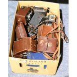 A box containing a small collection of photographic equipment including vintage Lubitel, Ikoflex and