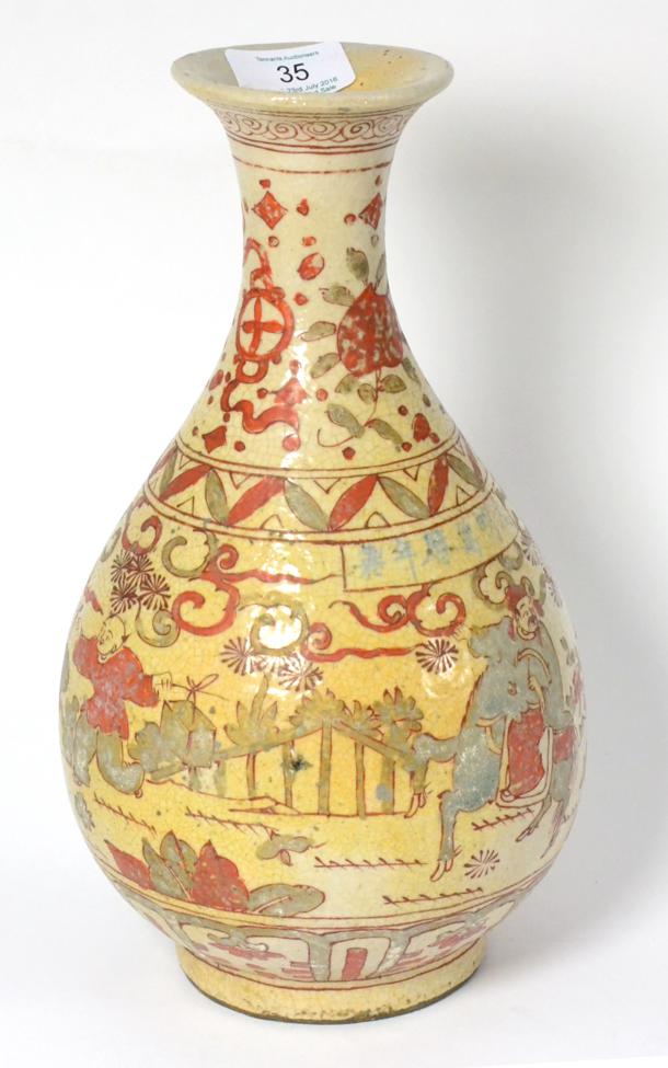A Chinese Provincial Porcelain Bottle Vase, painted in blue and red enamels with a procession within