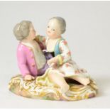 A Meissen Porcelain Figure Group, late 19th century, as a boy and girl sitting on a mound, on a