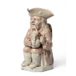 A Ralph Wood Type Pottery Toby Jug, circa 1780, of traditional form holding a jug and smoking a