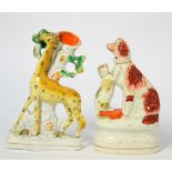A Staffordshire Pottery Spill Vase, 19th century, modelled as a giraffe standing before a tree on