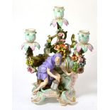 A Meissen Porcelain Figural Candelabrum, late 19th century, representing Winter from a set of the