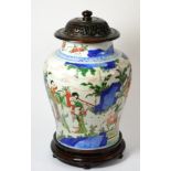 A Chinese Wucai Porcelain Baluster Jar, in Kangxi style, painted with mothers and children in a