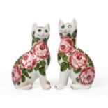 A Near Pair of Wemyss Pottery Cats, circa 1910, each seated with glass eyes, painted with pink