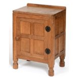 A Robert ''Mouseman'' Thompson Panelled Oak Bedside Cupboard, with raised upstand, above a single