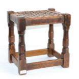 A 1930s/40s Robert ''Mouseman'' Thompson Oak Stool, with lattice leather top, on four octagonal legs