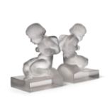 A Pair of René Lalique Amour Clear and Frosted Glass Bookends, each modelled as seated winged