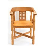 A Robert ''Mouseman'' Thompson Oak Monks Chair, with curved back and shaped arms, over three lattice