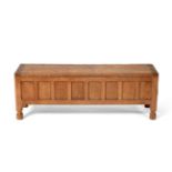 A Robert ''Mouseman'' Thompson Panelled Oak Blanket Box, with wrought-iron hinges, on four octagonal