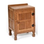 A Robert ''Mouseman'' Thompson Panelled Oak Bedside Cupboard, with raised upstand, above a single