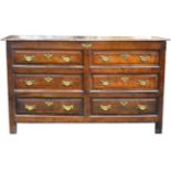 A George III Joined Oak Chest, circa 1760, the hinged lid above four sham drawers and two real