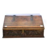 An English Oak Desk Box, carved 1674 and initialled MT, the hinged lid with metal hinges enclosing