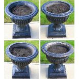 A Set of Four Victorian Cast Iron Campana Urns, of fluted form on square bases, 52cm high, painted