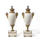 A Pair of Gilt Metal Mounted White Marble Urns and Covers, of baluster form with Bacchus mask