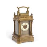 A Small Gothic Style Brass Carriage Timepiece, circa 1900, carrying handle, turned finials and