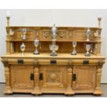 A Victorian Carved Oak Sideboard, the superstructure of breakfront form with dentil cornice above