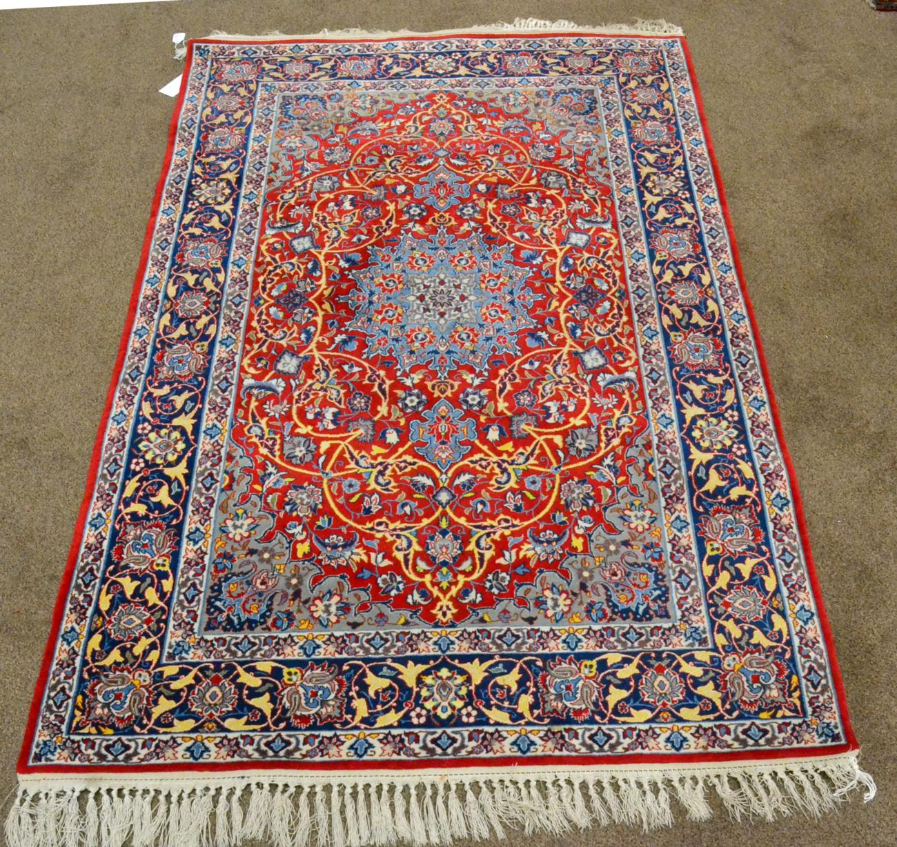 A Finely Knotted Isfahan Rug Central Iran The crimson field of scrolling floral vines around an