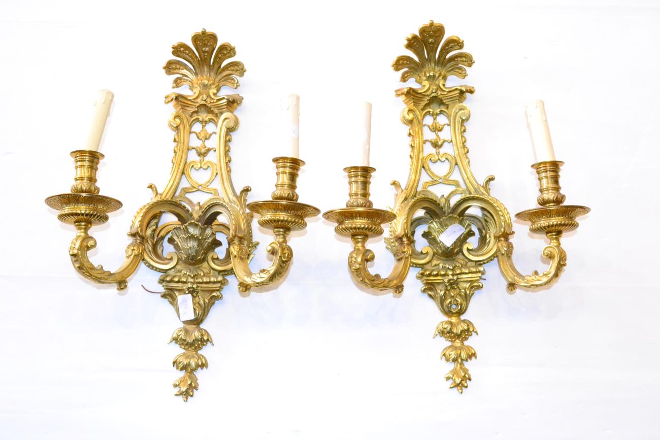A Pair of Gilt Bronze Two-Branch Light Fittings, in Régence style with shell cresting, pierced,