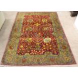 Indian Rug The raspberry field of Shah Abass design enclosed by steel grey borders of palmettes