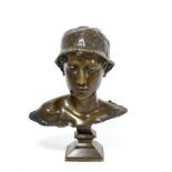 Milquese: A Bronze Bust of a Young Man, wearing a cap, on a swept square socle, indistinctly signed,