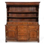 An 18th Century Oak Dresser, probably Shropshire/Staffordshire, the bold cornice above three fixed