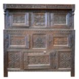 A Carved Oak Court Cupboard, with initials RH and dated 1689, carved overall with guilloche