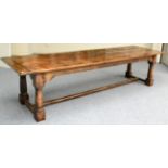 An English Joined Oak Refectory Table, the three plank top with cleated ends, raised on turned gun