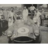 A Signed Photographic Print of Roy Salvadori with the 1963 Emu Aston Martin DB3, framed and