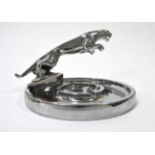 A 1950s Jaguar Chrome Car Mascot, mounted on a circular chrome ashtray base, 17.5cm diameter Buyer's