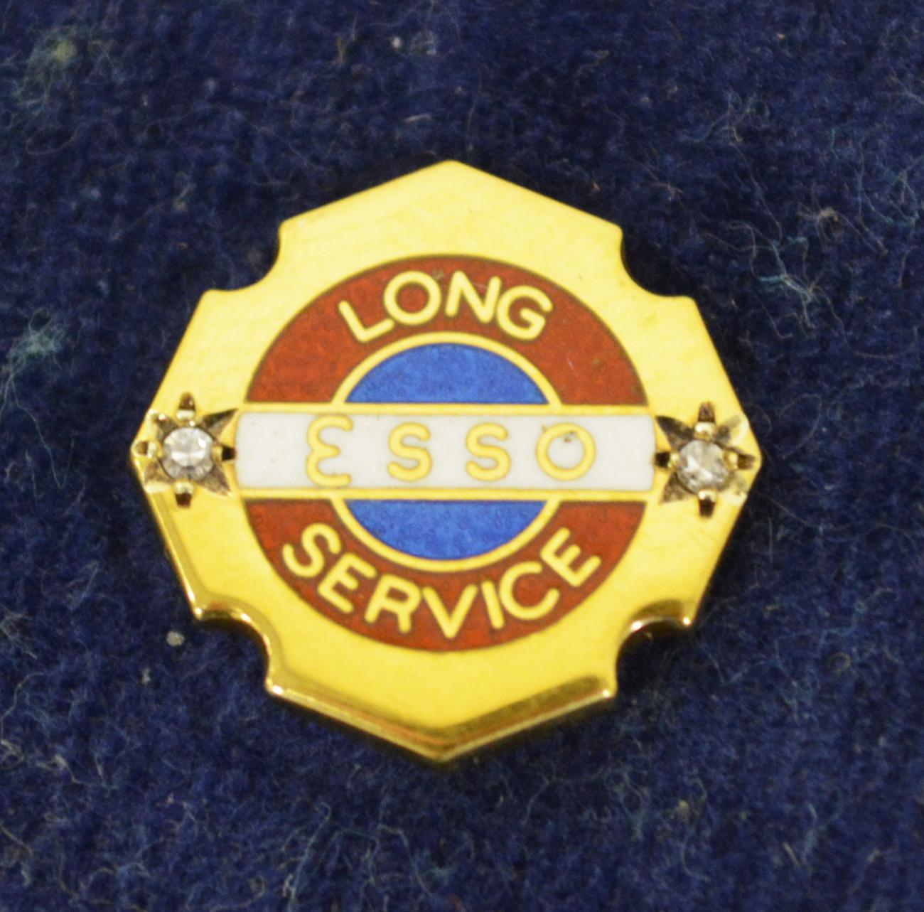 A 9ct Gold and Enamel Lapel Pin, stamped Esso Long Service, with two small diamond chips, the