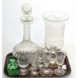 A glass celery vase, six small glasses, a glass decanter and a pair of Victorian paperweights