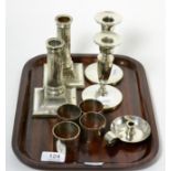 Two pairs of silver candlesticks, four silver napkin rings and a small Scottish silver