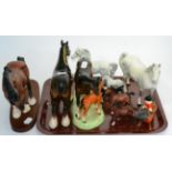 A collection of Beswick pottery models including dapple grey and brown horses, Freisian calf and a