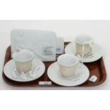 Five various Lladro pieces including three cups and saucers and two plaques, one signed (5) One