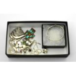 A collection of silver jewellery including a Mexican abstract brooch, a turquoise set cross, three