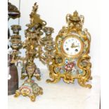 A French champleve enamel striking mantel clock with garniture