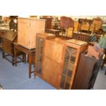 A quantity of furniture including a 1950s display cabinet with fall front writing compartment, a