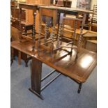 A 1920s oak drop leaf dining table and two barley twist occasional tables of similar date