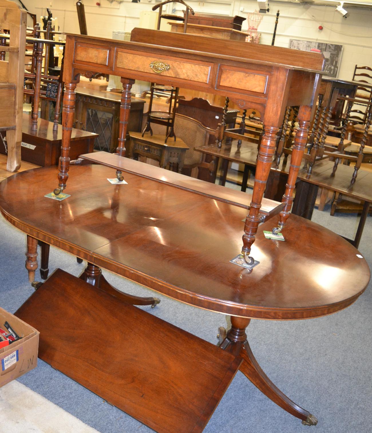 A reproduction dining table with matching bow fronted sideboard and a walnut washstand