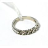 An 18ct white gold diamond half hoop ring