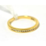 An 18ct gold diamond half hoop ring