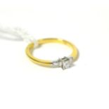 An 18ct gold princess cut diamond ring with tapered baguette shoulders