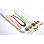 A jade necklace, a coral necklace, a bakelite necklace, a silver chain necklace, a Scottish silver