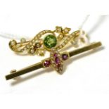 An 18ct peridot and split pearl bar brooch and an 18ct ruby and split pearl bar brooch