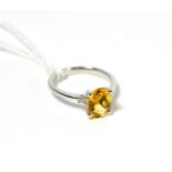 A citrine and diamond three stone ring